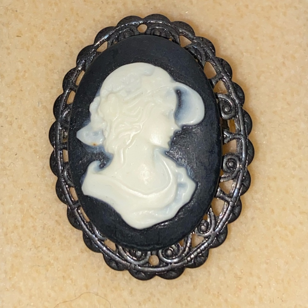 Cameo pin, white on black